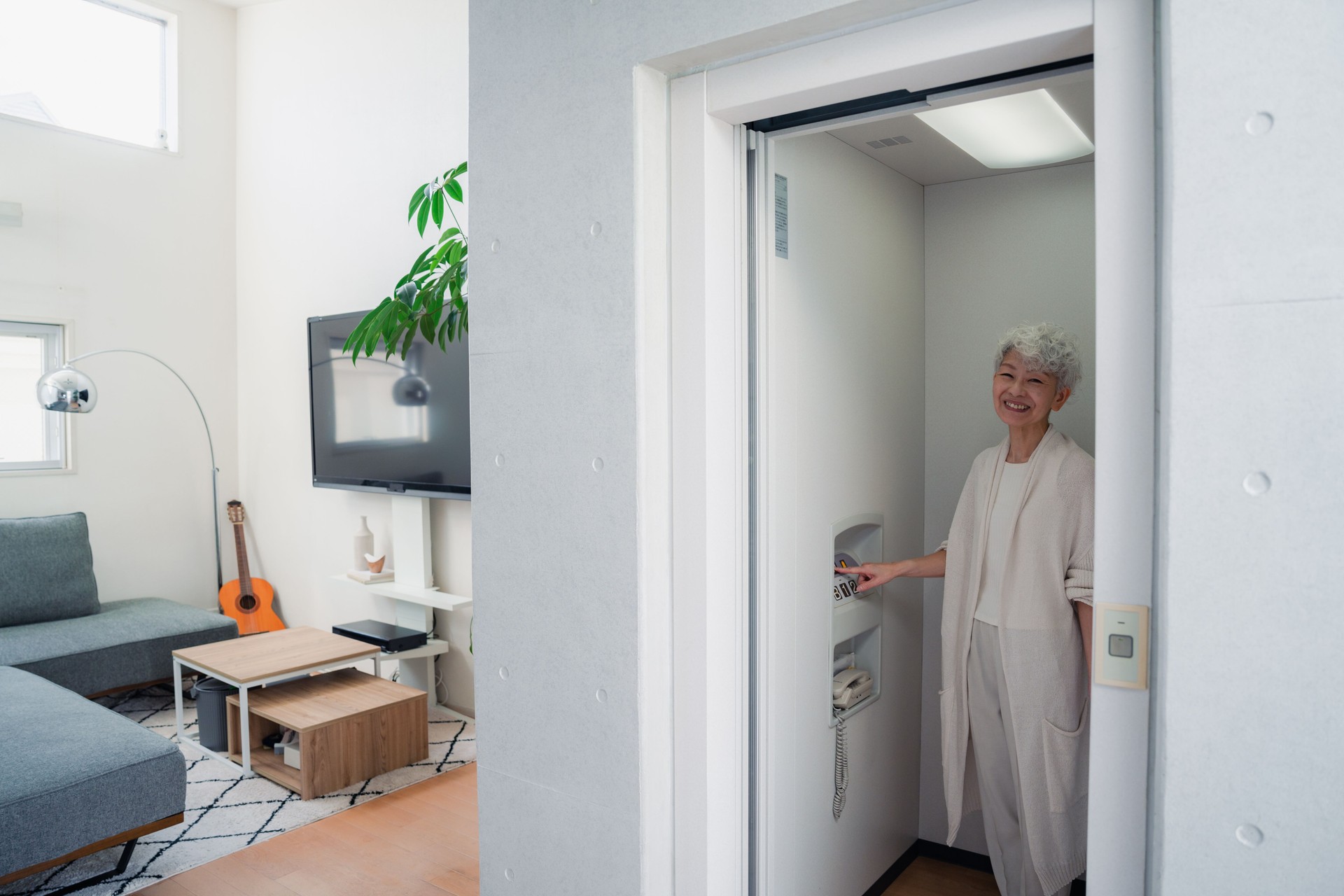 Senior woman using home elevator